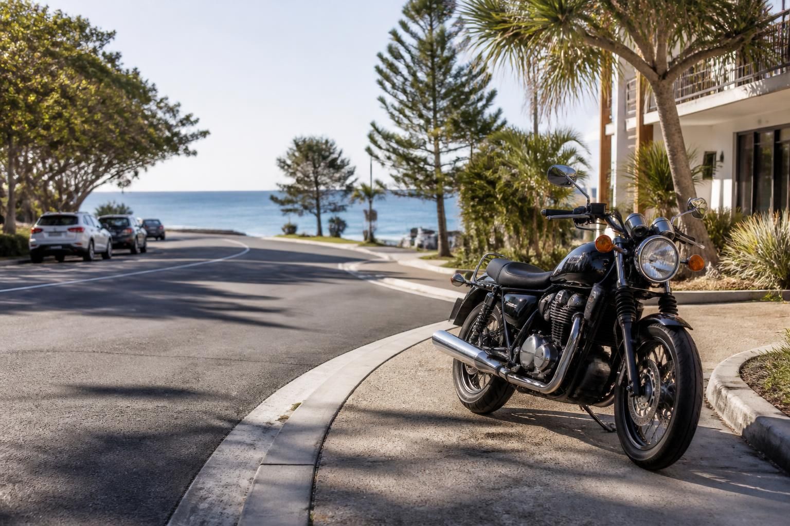 Sunshine Coast road scene with a parked motorcycle in bright daylight.